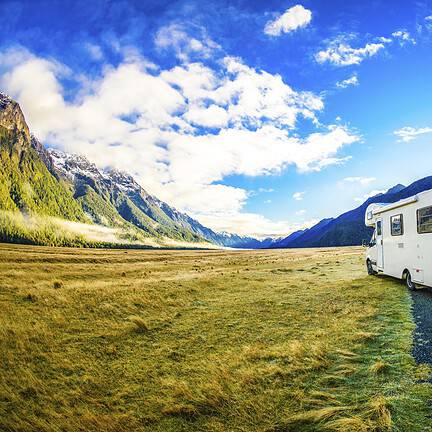 Uitzicht op de bergen met een camper op de weg in Nieuw-Zeeland