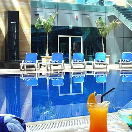 Cocktails bij het zwembad van Ghaya Grand Hotel in Dubai