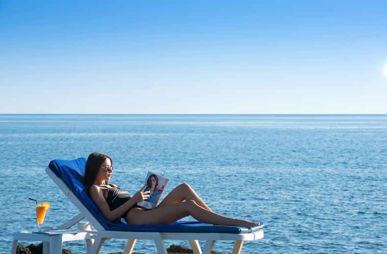Vrouw ligt op het strand van Silva Beach Resort in Chersonissos, Kreta