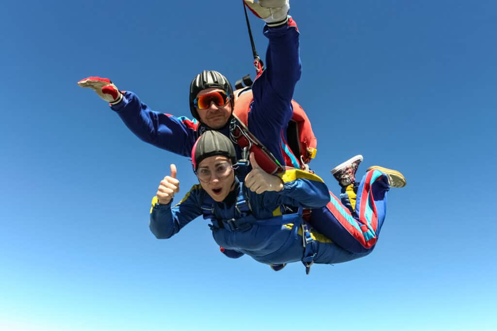 Man en vrouw doen een tandemsprong met een parachute